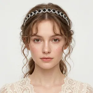 Close-up detail of an elegant rhinestone headband with black oval gemstones on a model