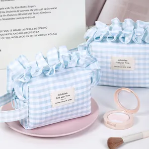 Fresh blue checkered cosmetic bag with ruffled edges and portable side handle