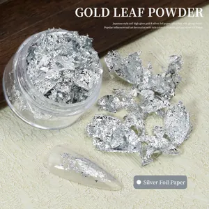 Detailed view of silver nail art foil flakes with application on manicured nail tips