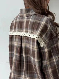Close-up of a retro brown and beige plaid shirt featuring delicate white lace detail on the back