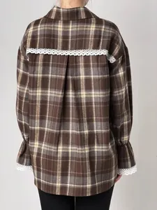 Back view of vintage brown plaid shirt featuring delicate white lace trim and loose fit