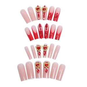 Elegant long coffin press-on nails with red gradient and luxury heart rhinestones decor