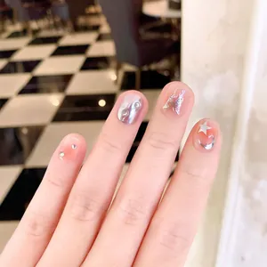 Handmade press-on nails featuring sparkling butterflies and liquid metal moon star charms