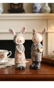 Encantadoras figuras de pareja de conejos de resina en un entorno vintage cottagecore