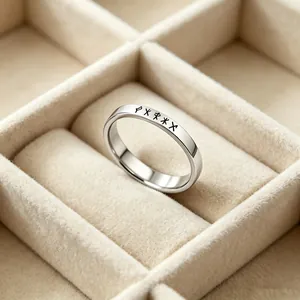 Detailed macro view of Nordic Rune engravings on a minimalist stainless steel band ring.