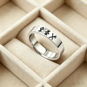 Detailed macro view of silver stainless steel ring with black Nordic Rune engravings