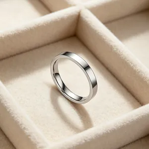 Macro view of minimalist silver stainless steel band ring in velvet jewelry box.