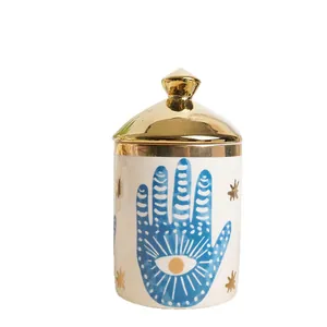 Bocal décoratif en céramique bohème avec main de Hamsa et mauvais œil, couvercle doré