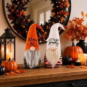 Close-up of two adorable Halloween gnomes with spooky text on a warm festive table