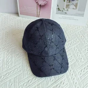 Primer plano de gorra de béisbol de mezclilla con rombos de lentejuelas y cuentas