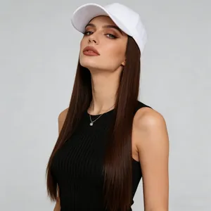 Detail view of a white baseball cap with long straight brown hair wig on a model