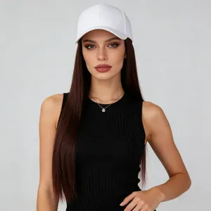 Close-up of a white baseball cap integrated with long straight reddish-brown hair on a model.