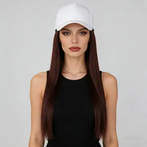 Close-up of a white baseball cap with long straight brown hair extensions on a model
