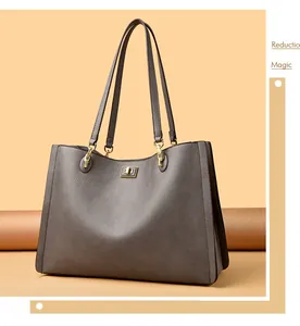 Gedetailleerde weergave van de grijze lederen shopper met goudkleurige hardware.