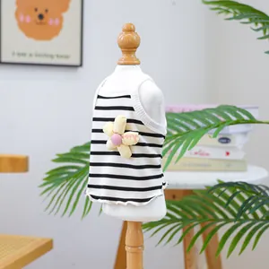 Close-up of a striped pet vest featuring a yellow flower patch on a white mannequin