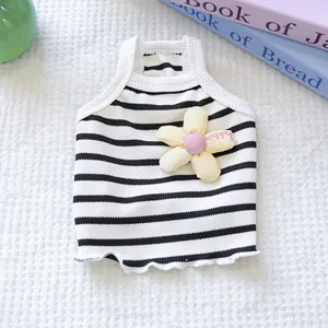Detail view of a striped pet vest featuring a cute yellow flower and soft knit texture