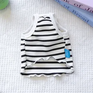 Close-up view of a cozy black and white striped pet vest showing brand logo tag detail