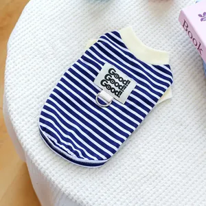 Detail view of blue striped pet vest with decorative patch and D-ring attachment