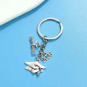 Detailed view of silver graduation keychain with 2026 charm and mortarboard