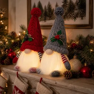 Close-up of glowing Christmas gnome dolls with festive knitted hats and decorations