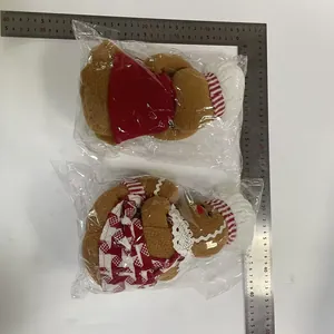 Two gingerbread man wine bottle covers with chef hats and measurement ruler detail