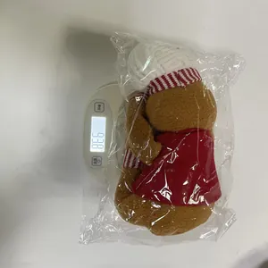Detailed weight measurement of gingerbread man plush toy in plastic packaging