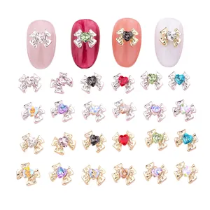 Exquisite nail art bow charms with colorful heart-shaped rhinestones for DIY manicure designs