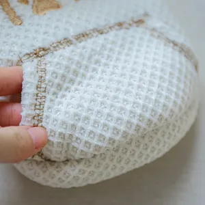 Close-up detail of white waffle fleece texture on pet hoodie garment