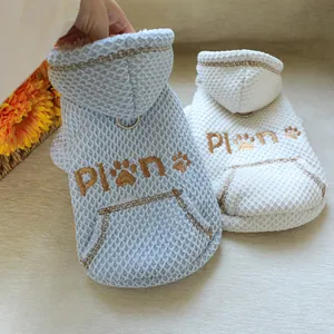 Detailed macro view of warm waffled textured pet hoodies with cute paw embroidery and pocket
