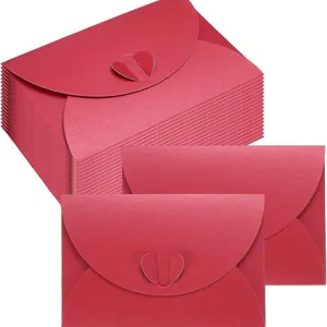 Elegant red pearlescent paper envelopes featuring a heart-shaped clasp for invitations