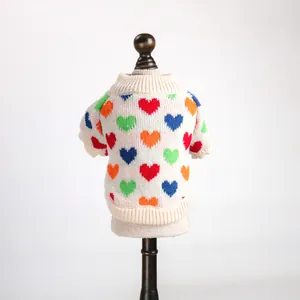 Back view of a white pet knit sweater with colorful heart patterns on a mannequin.