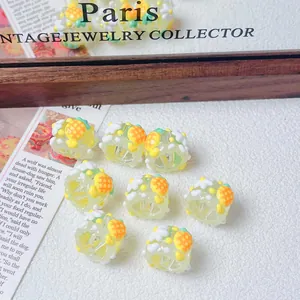 Close-up of hand-painted resin beads with cute yellow fruit patterns for DIY jewelry making