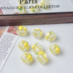 Close-up of cute hand-painted lemon fruit beads for DIY jewelry making