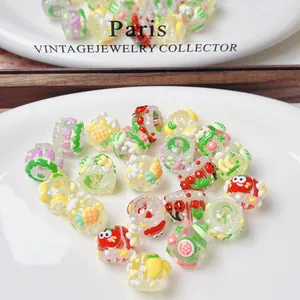 Detailed macro view of hand-painted colorful fruit beads for DIY jewelry making accessories