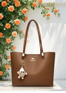 Detail view of large brown tote bag with elegant kangaroo logo and fluffy charm