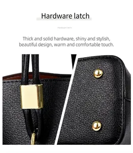 Close-up of polished gold hardware studs and latch on black textured leather tote bag