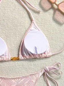 Gros plan montrant la texture et le rembourrage amovible du haut de bikini rose