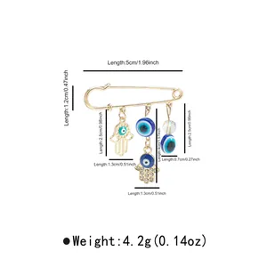 Detailed dimensions of the gold-tone evil eye and hamsa hand safety pin brooch