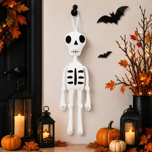 Close-up of a hanging knitted skeleton decoration in a Halloween-themed setting.