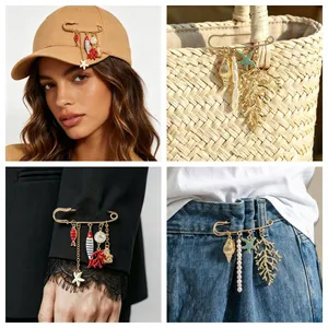 Ocean-themed safety pin brooch with coral and starfish charms shown in various styles