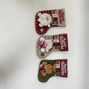 Detailed view of three 3D plush Christmas stockings featuring Santa, Snowman, and Reindeer