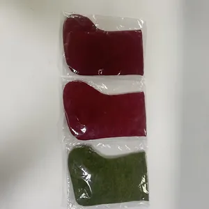 Detail view of three individually wrapped Christmas stockings in red and green felt
