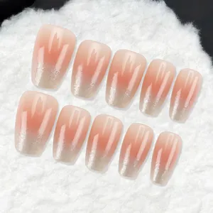 Elegant nude gradient press-on nails featuring silver glitter tips on a soft texture.