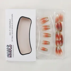 Detailed macro view of peach gradient press-on nails with silver glitter in retail packaging