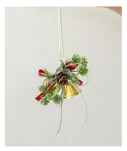 Close-up detail of a festive Christmas ornament featuring golden bells and pinecones
