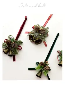 Detailed macro view of rustic Christmas ornaments featuring metal bells and pine cones