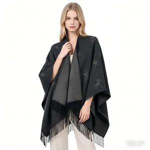 Detailed view of grey cashmere-like shawl with ginkgo leaf patterns and tassels
