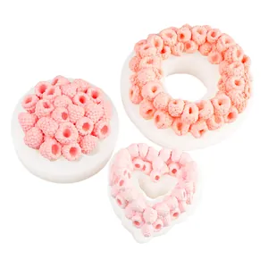 Detailed view of three DIY raspberry silicone molds for soap, heart and ring shapes