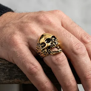 Close-up of golden stainless steel skull ring with intricate pirate-style detailing