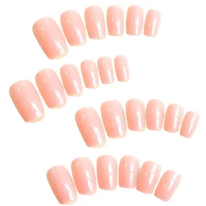 Glossy solid nude pink press-on nails set arranged on a clean white background